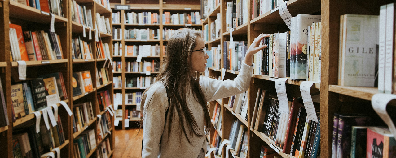Person browsing books in library